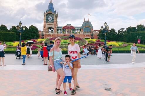 Two women and a child posing outside.