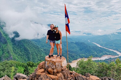 Two volunteers standing on a rock