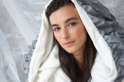Model displaying hooded garment created by students of Accademia del Lusso