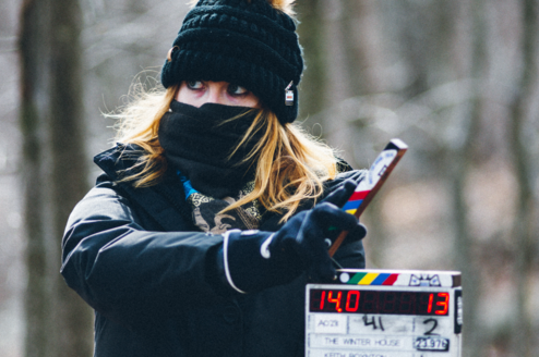 the 2nd AC holds up a slate at the start of a take