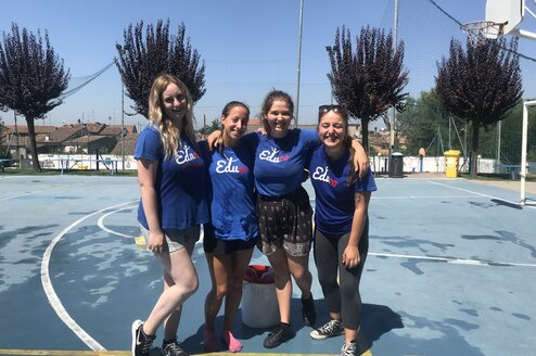 4 camp leaders smiling on basketball court