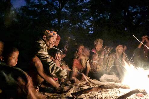 San Bushmen sitting around the fire at a Healing dance event