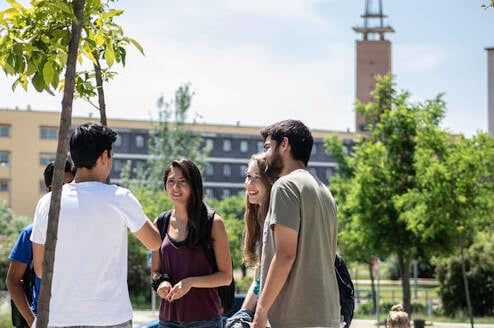 Students on campus with University tower in the background