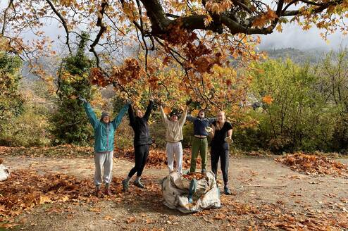 study abroad students playing in fall leaves