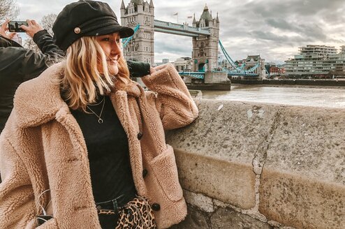 Woman looking at the Tower Bridge in London, England.