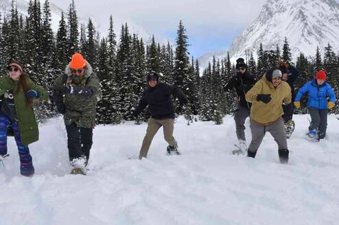 Youth running on snowshoes towards camera