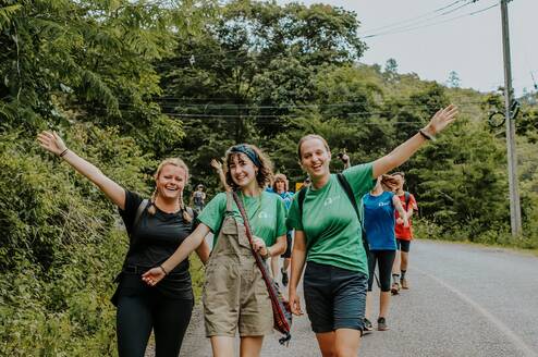 Emily K with her volunteer group walking on a street in Thailand