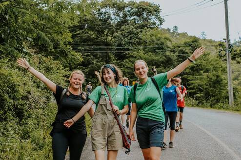 Emily K with her volunteer group walking on a street in Thailand