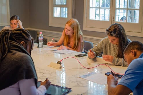 Sage Corps interns working together on their group presentation