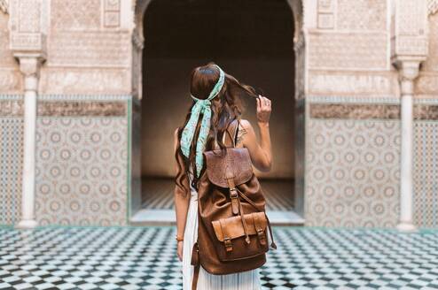 Traveler standing in front of building with backpack