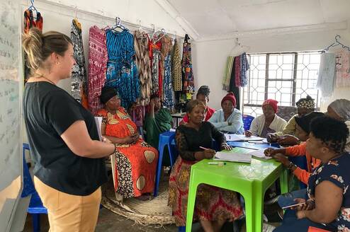 A Volunteer with women during session.