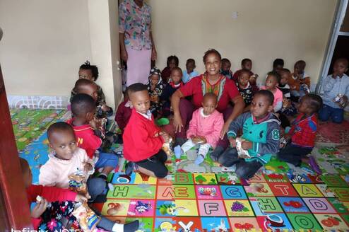 Caretaker with children at Childcare center.
