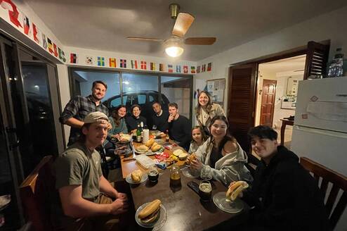 Group of travelers eating together at a table