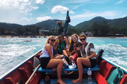 Samantha P on a boat in Thailand with other gap year students