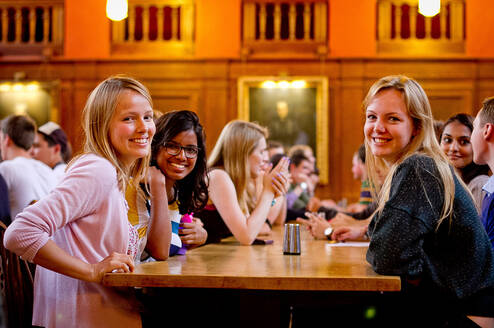 Students chatting and smiling in LMH Dining Hall