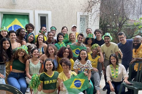 Students, faculty, and staff posing for a photo during a World Cup 2022 watch party