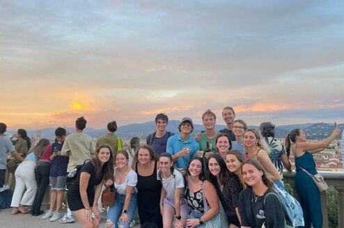 A group of CET Florence students posing in front of a sunset
