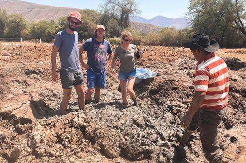 3 students preparing the mud to make adobe bricks
