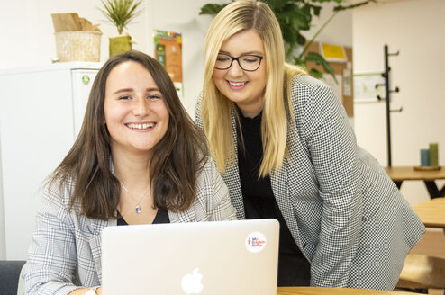 Two interns working at the office
