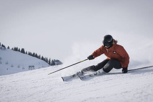 Woman skiing down a groomed piste