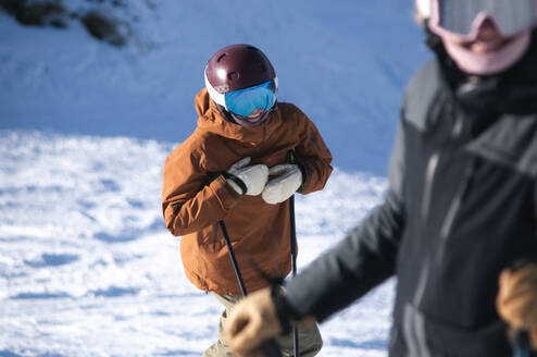 Women smiling at camera while skiing