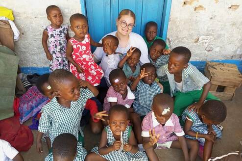 Childcare volunteer with children at James Town Gbekebii school in Accra