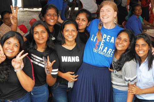 Teacher socialising with students at an event