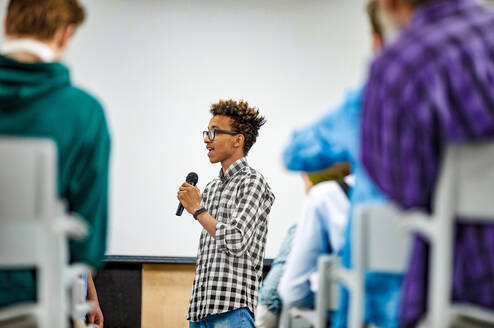 A student speaking through a microphone