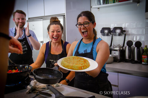 A proud student after cooking a Spanish dish