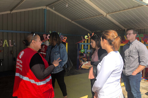 Students listening to a Save the Children worker speak 