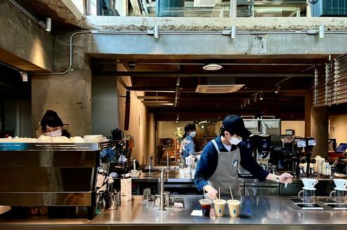 A man works at a cafe.
