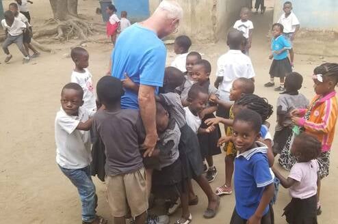 Dave surrounded by children from the refugee camp