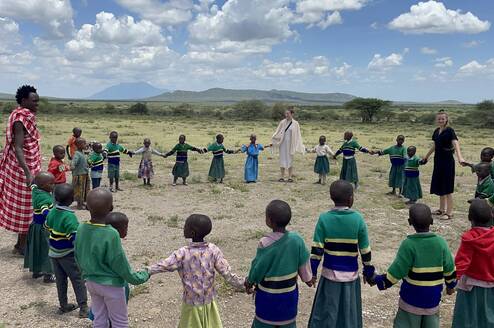 volunteer teachers playing with the students after a break from teaching 