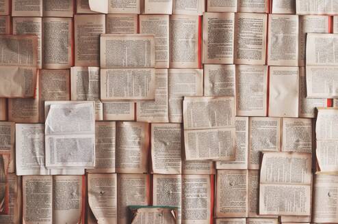 Opened books scattered across the floor