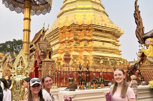 two girls pose in front of a tempe 