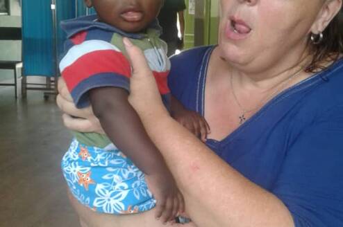 GXVO volunteer taking care of a child