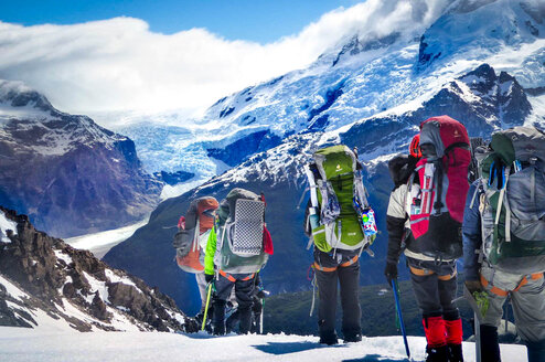 NOLS students crest the top of a mountain pass