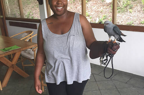 Student holding a raptor