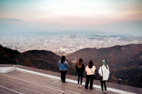 Four students overlooking beautiful city