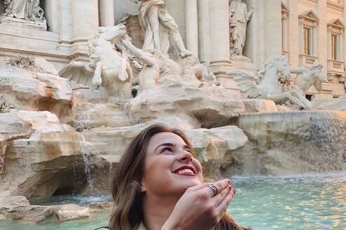 Participant throws a coin into the Trevi Fountain