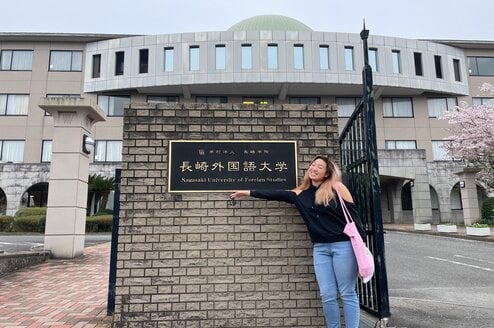Student pointing to a sign at a university in Japan