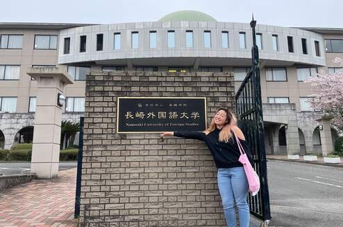 Student pointing to a sign at a university in Japan