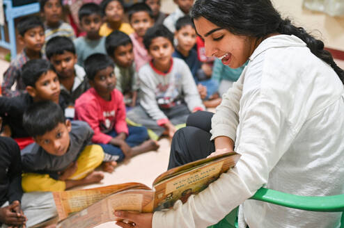 Volunteer reading to children.