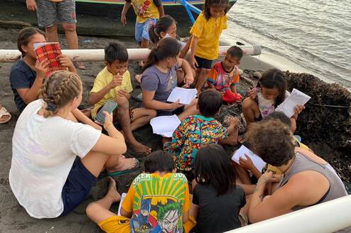 Learning session on the beach with school children facilitated by volunteers