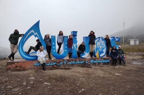 Students in Front of Quijos Sign