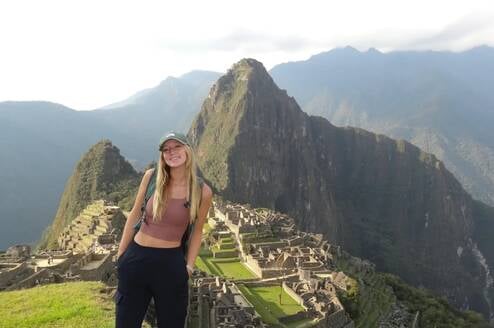 A person standing in front of Machu Picchu