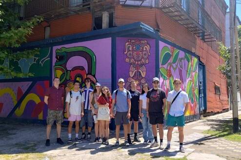 Gap internship group posing in front of street art in Buenos Aires