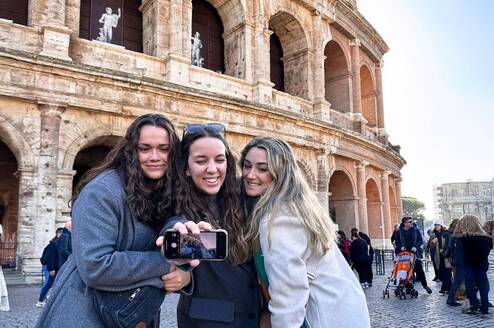 Students taking selfie in front of roman forum 
