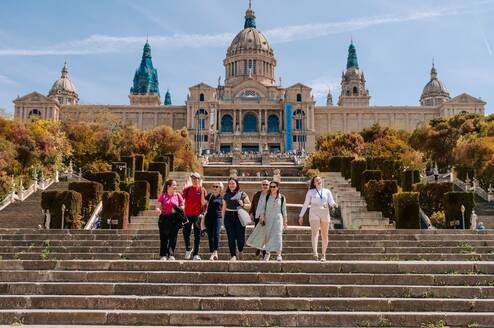 EF Gap Year students walking down the steps of the National Art Museum of Catalonia (MNAC) in Barcelona, Spain, enjoying a sunny day of art, history, and exploration.