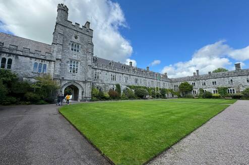 Large university building with grass in front